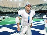 Former NFL great Warren Moon poses with his bust after enshrinement into  the Pro Football Hall of Fame Saturday, Aug. 5, 2006, in Canton, Ohio. Moon  quarterbacked the CFL Edmonton Eskimos before